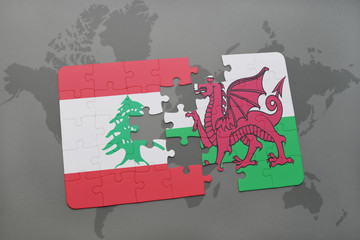 puzzle with the national flag of lebanon and wales on a world map background.