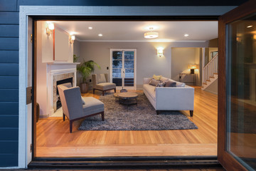 Open double french doors looking into a living room.