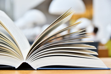 Hardcover book lying on the table in a library