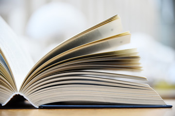 Hardcover book lying on the table in a library