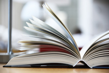 Hardcover book lying on the table in a library