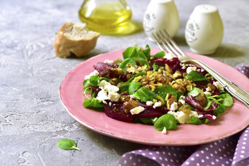 Beetroot salad with raisins,walnuts,feta and greeen leaves mix.