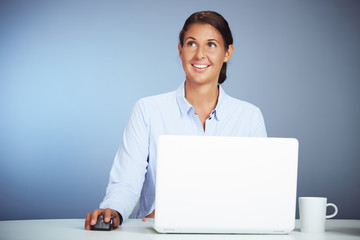 Beautiful Businesswoman Working On Her Laptop Is Having A Daydream Thinks About Something