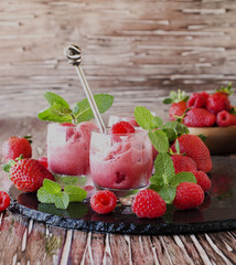 frozen yogurt, sorbet with strawberries, raspberries and mint, selective focus