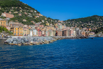 Camogli marina harbor, boats and typical colorful houses. Travel destination Ligury, Italy, Europe.