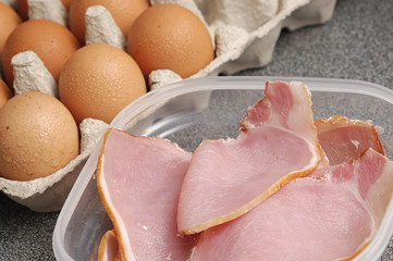Uncooked bacon and eggs