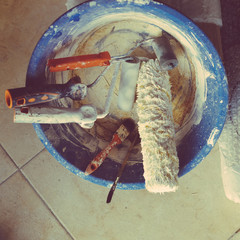 Closeup on used brushes and paint-roller, top view