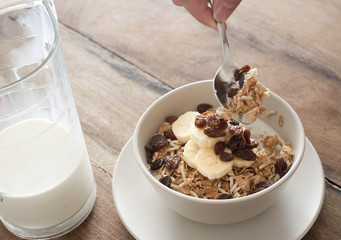 Spoon scooping cereal out of little bowl