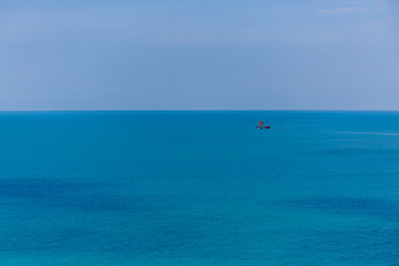 Fototapeta na wymiar The boat in the azure ocean