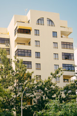 Fototapeta premium Beautiful architectural flat building construction over blue sky background