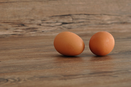 Two eggs isolated on a wooden background