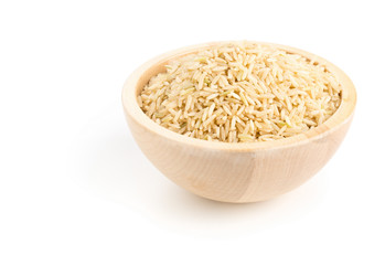 Natural brown uncooked rice in wooden bowl