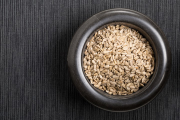 Shelled sunflower seeds in black mortar