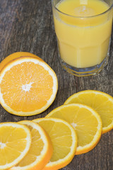 Orange juice slices with orange and glass of juice
