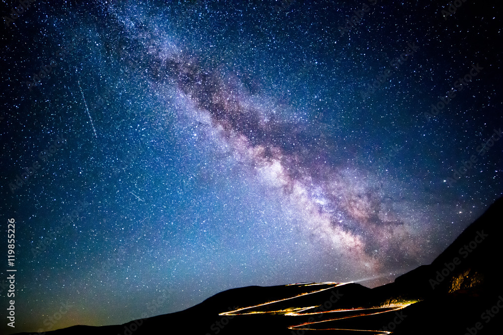 Wall mural milky way and traffic trails on transalpina carpathian pass, in romania