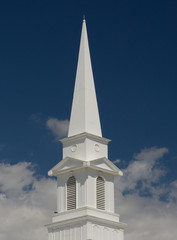 Christian Church steeple rising from clouds