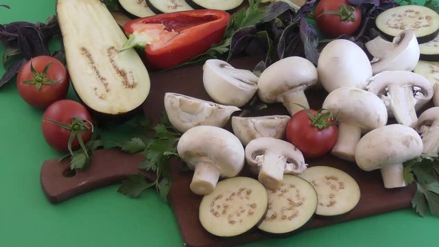 Champignon and fresh vegetables on a kitchen table for cooking dishes from mushrooms