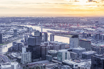 Naklejka na ściany i meble Melbourne, Australia - August 27, 2016: Aerial view of Melbourne CBD with skyscrapers, Yarra River, and Bolte Bridge at sunset