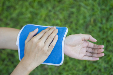 woman putting an ice pack on her arm pain