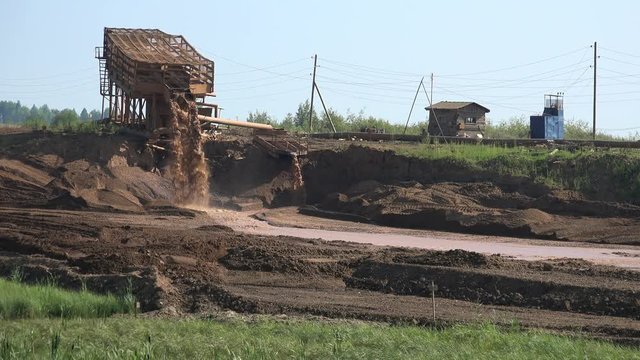 Gold mining in Ural mountains near Nevyansk. Dredge separator on river dragging gold sand