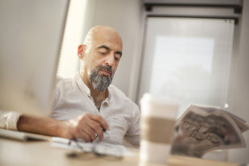 Portrait of businessman reading newspaper