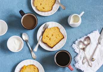 Pumpkin cake and coffee on a blue background. Delicious dessert, breakfast or snack