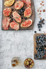 Different snacks for wine on wooden board