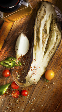 Baked eggplant with tomatoes cherry, onions, olive oil and chili