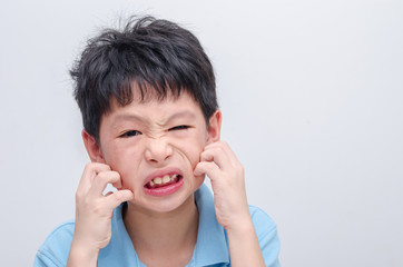 Young asian boy scratching his allergy face