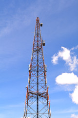 Communication antenna tower with blue sky background, Top of a cellular radio tower. Wireless technology for portable transceivers such as mobile, cell, smart phones, pagers, tablets. Mobile network.