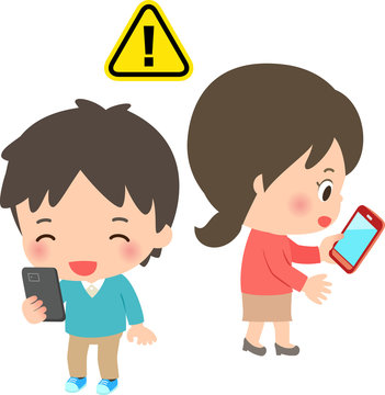 スマートフォンを使いながら歩く男女