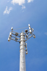 Obraz premium Telecommunication mast television antennas on blue sky. Site, mobile operator antenna or aerial. Cell phone base station, mobile phone network. Cell site, cell tower or cellular telephone site.