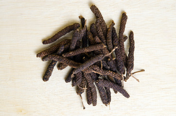 Long pepper or Pipli or Dipli (Piper longum) isolated on wood ba