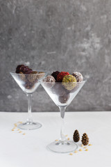 Colorful candies on a gray background in the glass