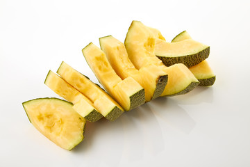 Hamigua Melon cut into slices, Hami Melon, Hami Cantaloupe isolated on white background.