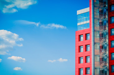 modern building on a background of blue sky with clouds