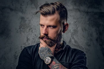  Bearded hipster with tattooe on his arms. © Fxquadro