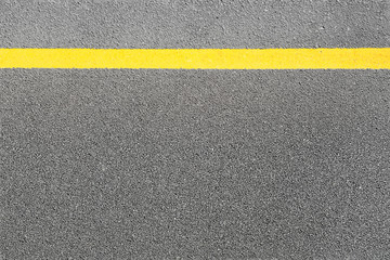 Fototapeta premium Black asphalt tarmac road or street and yellow line on top view