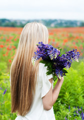 Fototapeta premium girl with bouquet of lupine flowers
