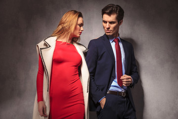 dramatic young elegant couple posing together in studio