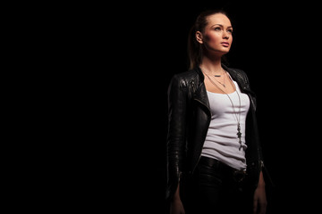 side view of a  woman in leather clothes looking up