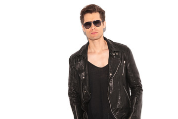 cool rock and roll man wearing leather jacket and sunglasses