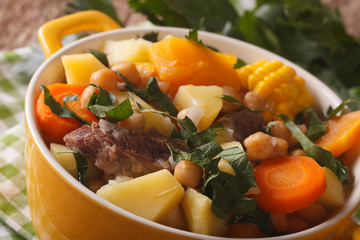 Puchero Argentine soup with chickpeas close-up in a pot. horizontal
