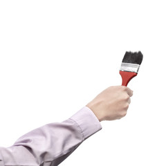 The hand holding paint brush