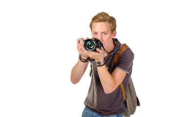 Young man traveler taking pictures by dslr camera isolated on white