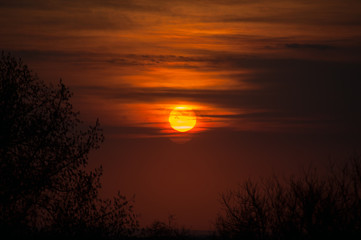 Fototapeta na wymiar Beautiful sunset in the haze of clouds