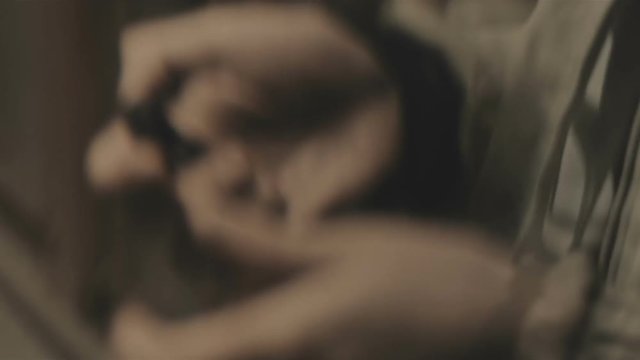 A young man lights a cigarette