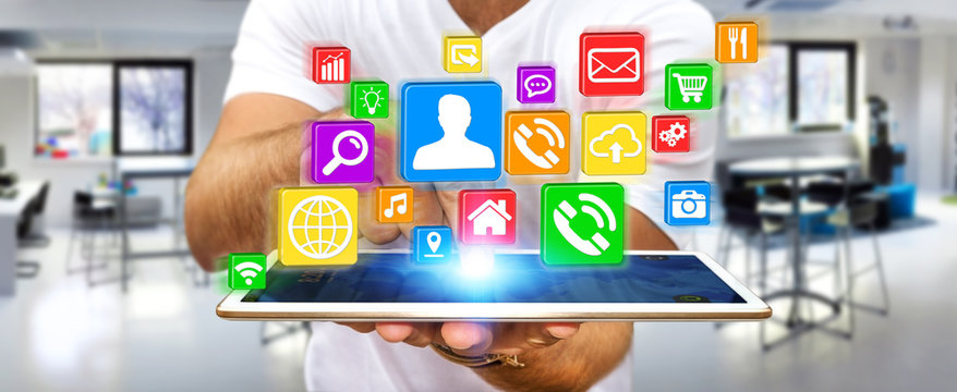 Businessman using modern digital icon application on his tablet