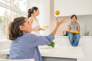 Mother cooking healthy meal for children