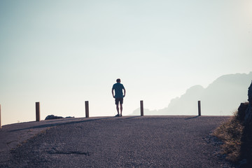 landscape view of great mountains and woman silhouette, watching panorama